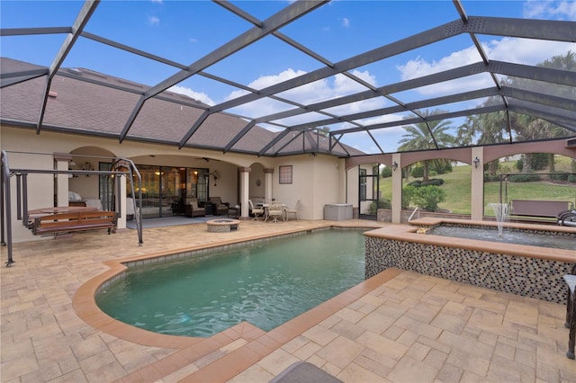 view of pool with pool water feature, a lanai, and a patio area