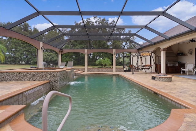 view of pool featuring glass enclosure, pool water feature, a grill, area for grilling, and a patio area