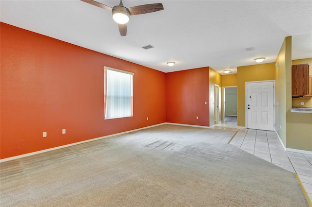 unfurnished room with ceiling fan and light colored carpet