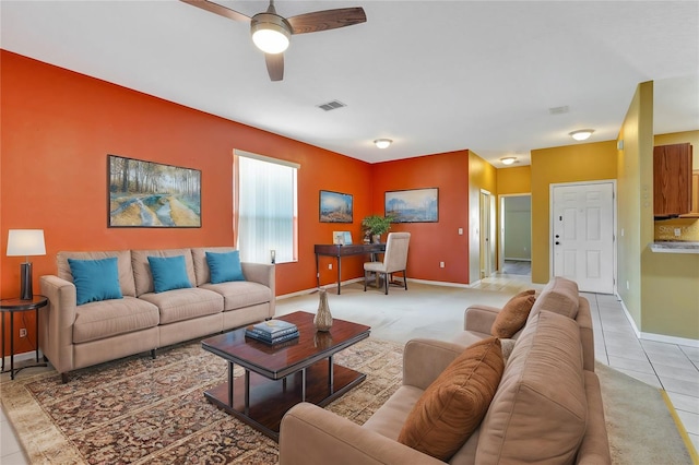 tiled living room featuring ceiling fan