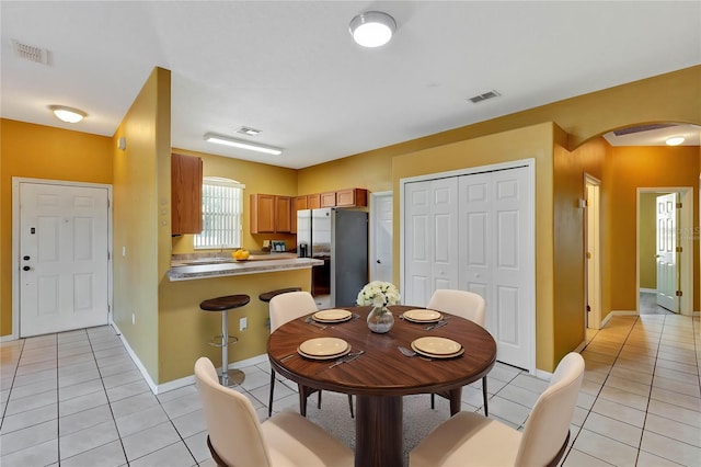 dining area with light tile patterned floors