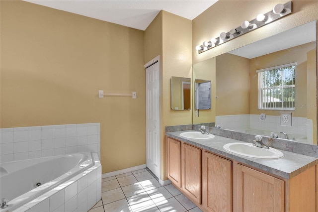 bathroom featuring tile patterned floors, vanity, and a relaxing tiled tub