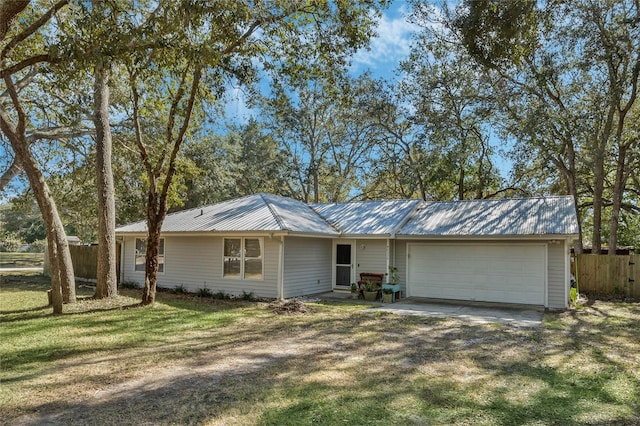 ranch-style home featuring a garage and a front yard