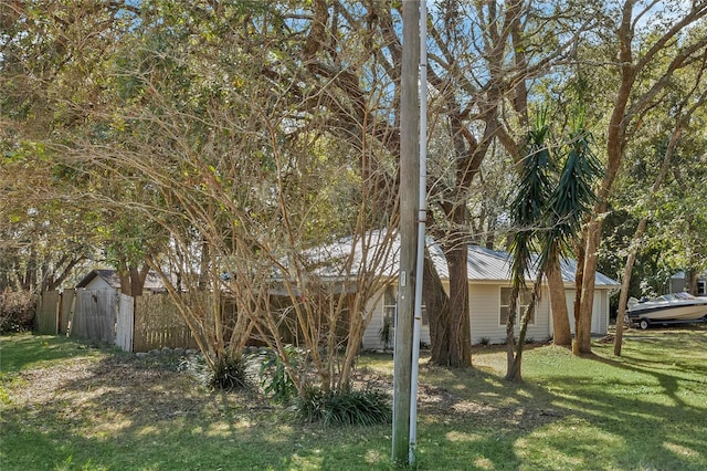 view of side of home featuring a yard