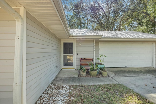 doorway to property with a garage