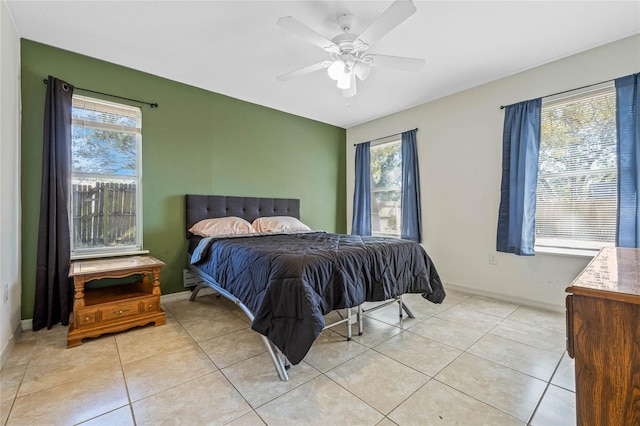 tiled bedroom with multiple windows and ceiling fan