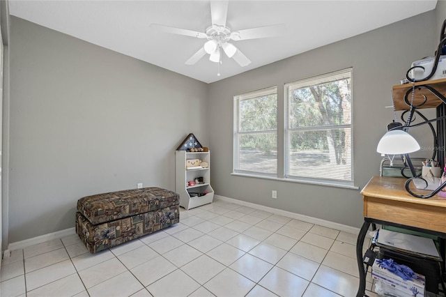 living area with ceiling fan and light tile patterned floors