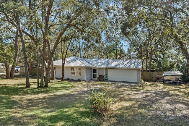 ranch-style house featuring a garage and a front lawn