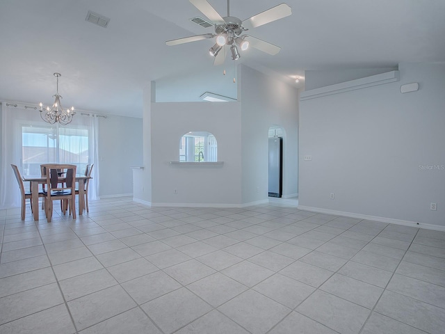 unfurnished living room featuring vaulted ceiling, a healthy amount of sunlight, and light tile patterned flooring