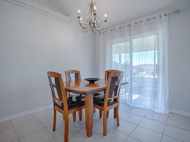 tiled dining room featuring a chandelier