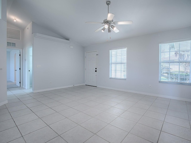 tiled spare room with lofted ceiling, a wealth of natural light, and ceiling fan