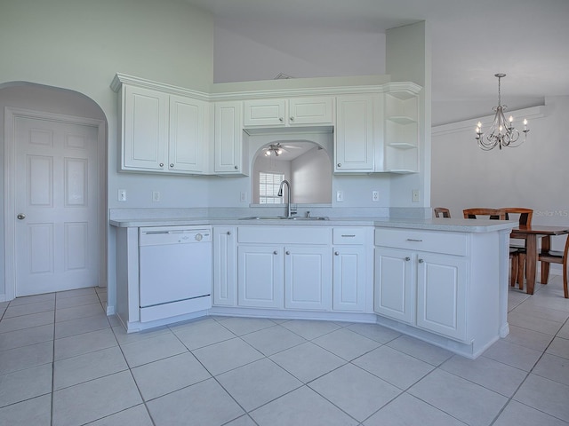 kitchen with sink, light tile patterned floors, dishwasher, kitchen peninsula, and white cabinets