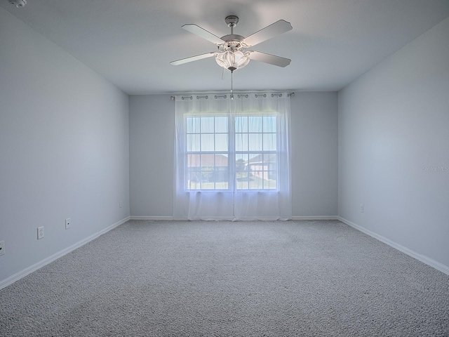 carpeted empty room featuring ceiling fan