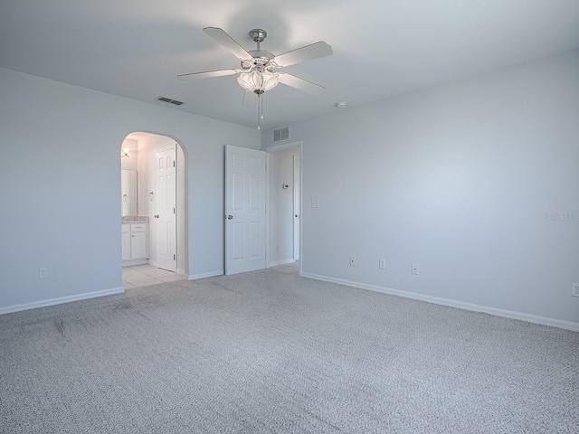 empty room featuring ceiling fan and light colored carpet