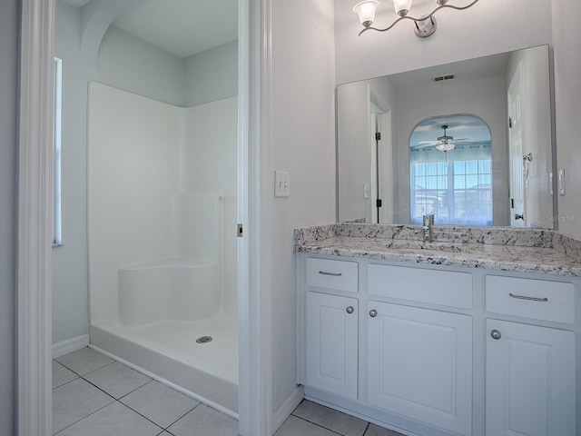 bathroom featuring vanity, tile patterned floors, ceiling fan, and walk in shower