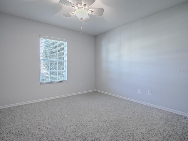 spare room with carpet flooring and ceiling fan