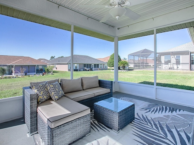 sunroom featuring ceiling fan