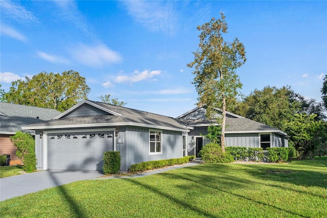 ranch-style house featuring a garage and a front yard