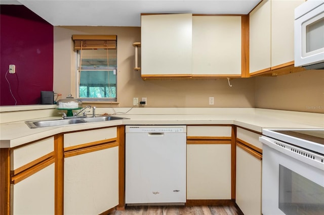 kitchen featuring white cabinets, white appliances, light hardwood / wood-style flooring, and sink