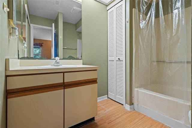 bathroom featuring shower / bath combination with curtain, vanity, and hardwood / wood-style flooring