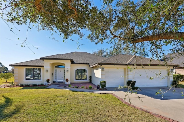 view of front of home with a garage and a front lawn