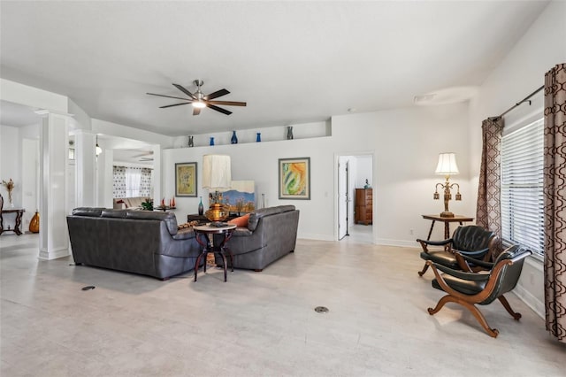 living room featuring decorative columns and ceiling fan