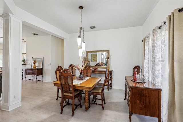 dining space featuring decorative columns