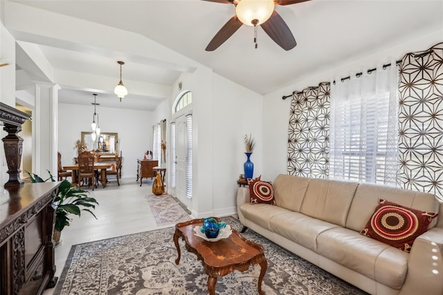 tiled living room with ceiling fan, a healthy amount of sunlight, ornate columns, and vaulted ceiling