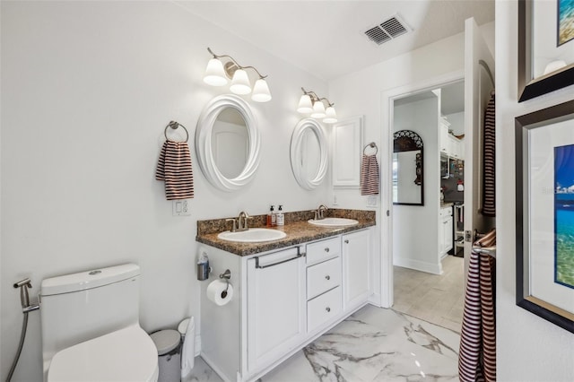 bathroom with vanity and toilet