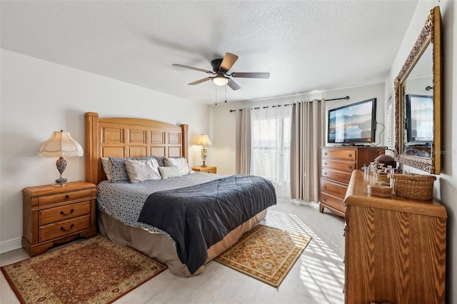 bedroom with a textured ceiling and ceiling fan