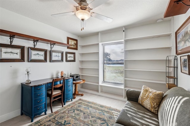 home office with ceiling fan and a textured ceiling