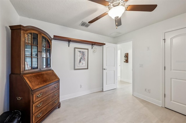 interior space with ceiling fan