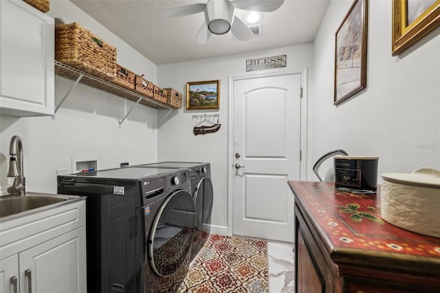 clothes washing area with ceiling fan, cabinets, independent washer and dryer, and sink