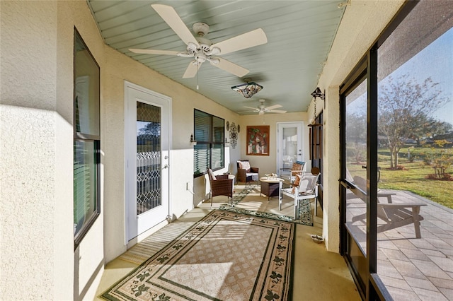 sunroom featuring ceiling fan