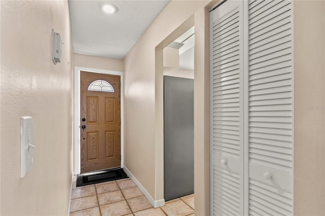 doorway to outside featuring light tile patterned floors