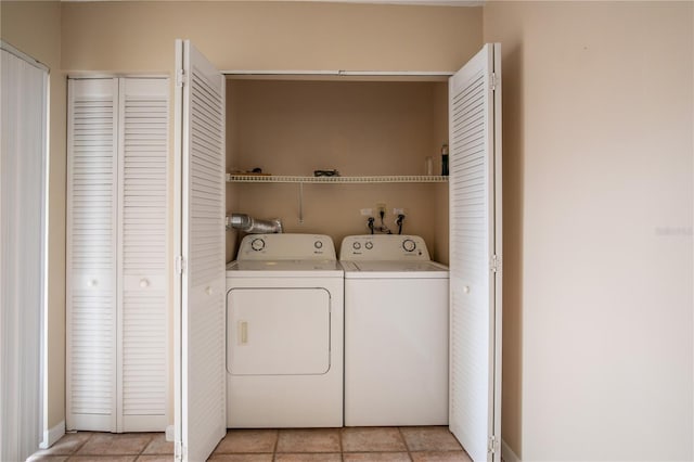 laundry room featuring separate washer and dryer and light tile patterned flooring