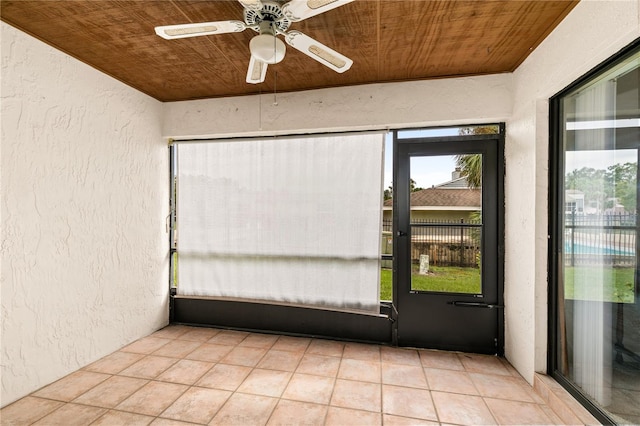 unfurnished sunroom with ceiling fan and wood ceiling