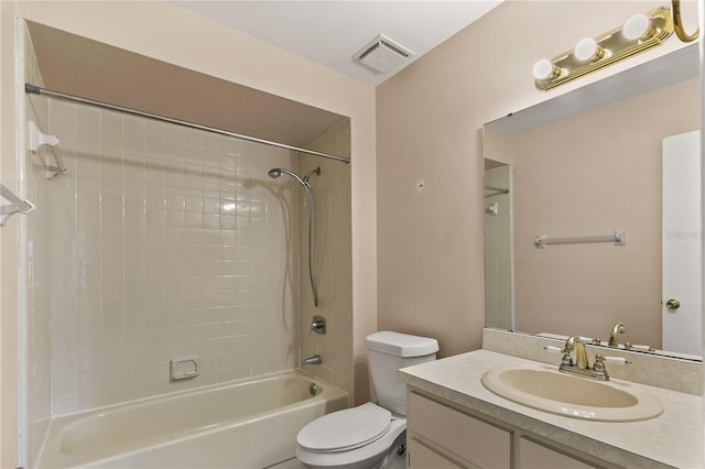 full bathroom with vanity, tiled shower / bath combo, and toilet