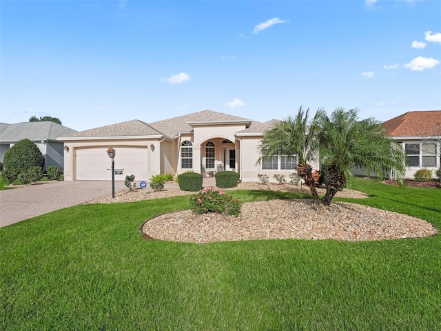 view of front of home with a front yard and a garage