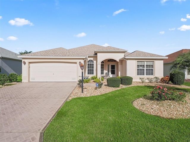 view of front of house featuring a front yard and a garage