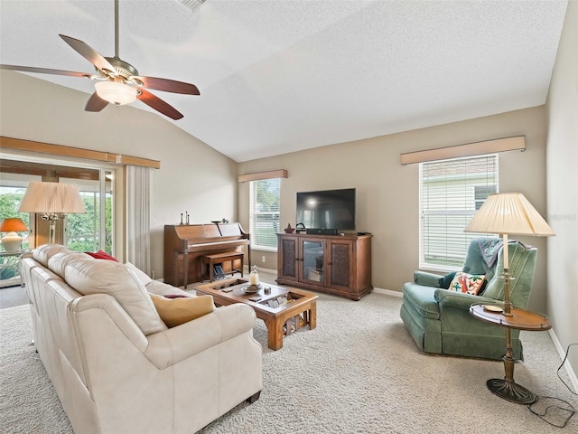 living room with ceiling fan, a healthy amount of sunlight, light colored carpet, and lofted ceiling