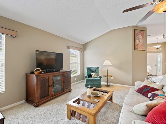 carpeted living room with a textured ceiling, ceiling fan, and vaulted ceiling