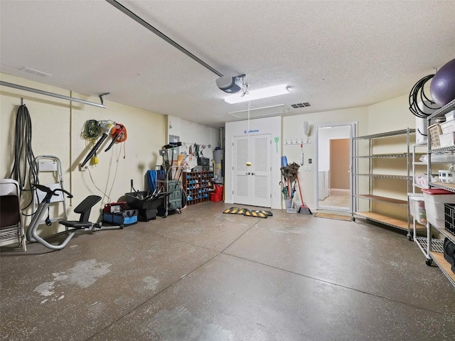 garage featuring a garage door opener and water heater