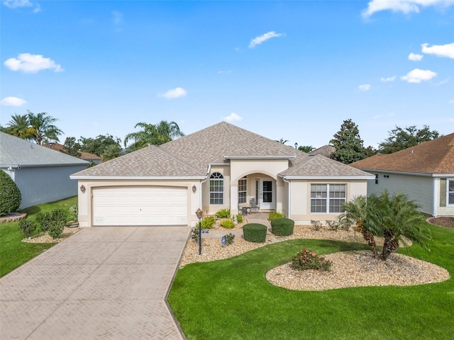 single story home featuring a front yard and a garage