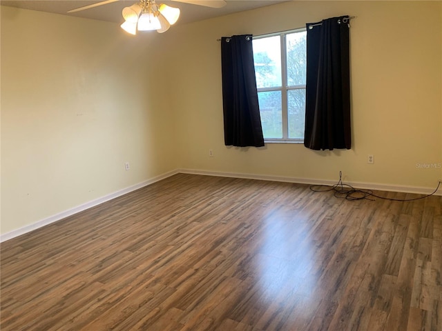 spare room with ceiling fan and dark hardwood / wood-style floors