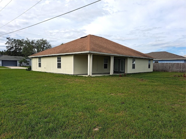 rear view of house with a lawn