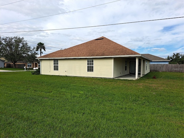 view of side of property with a yard and a patio area