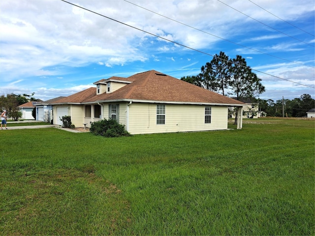 view of home's exterior featuring a lawn and a garage