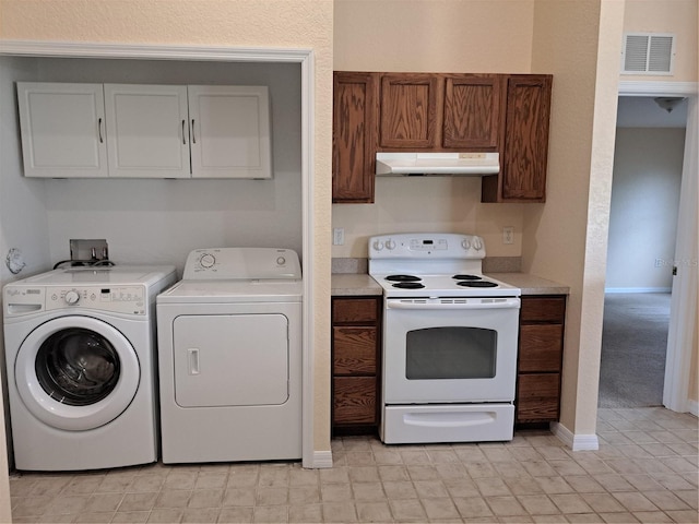 kitchen featuring washing machine and clothes dryer and white electric range