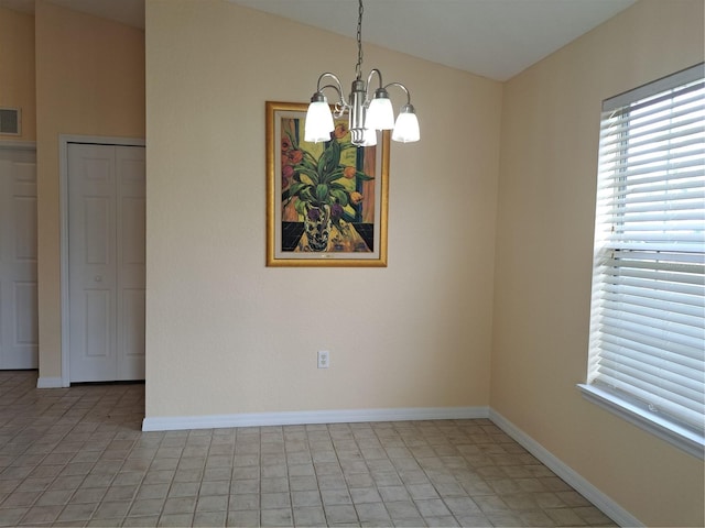 tiled spare room featuring vaulted ceiling and an inviting chandelier